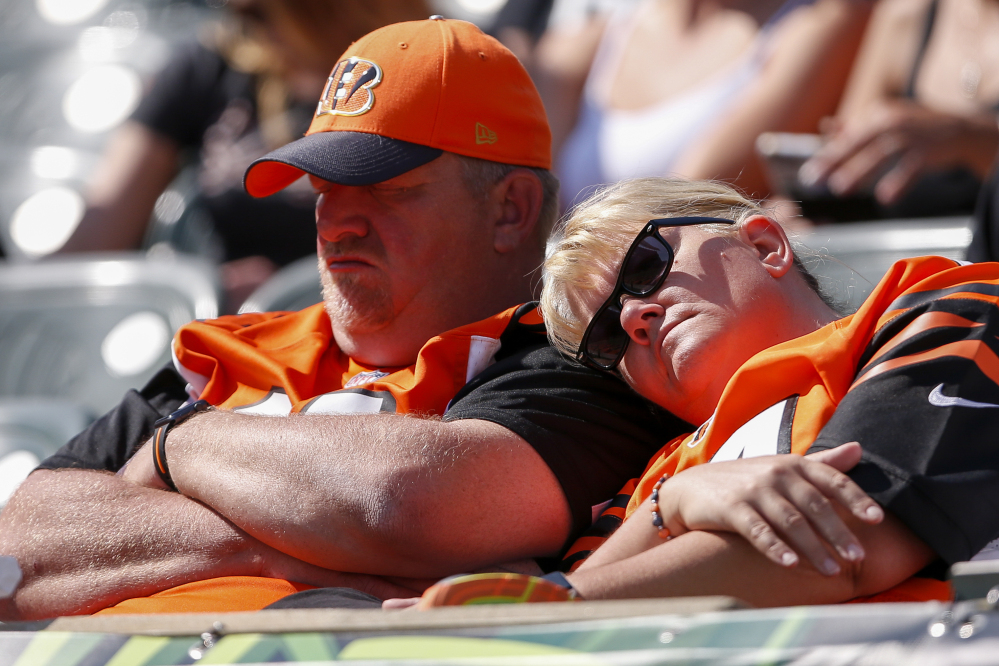 Cincinnati Bengals fans rest in the second half of a game against the Baltimore Ravens on Sunday.