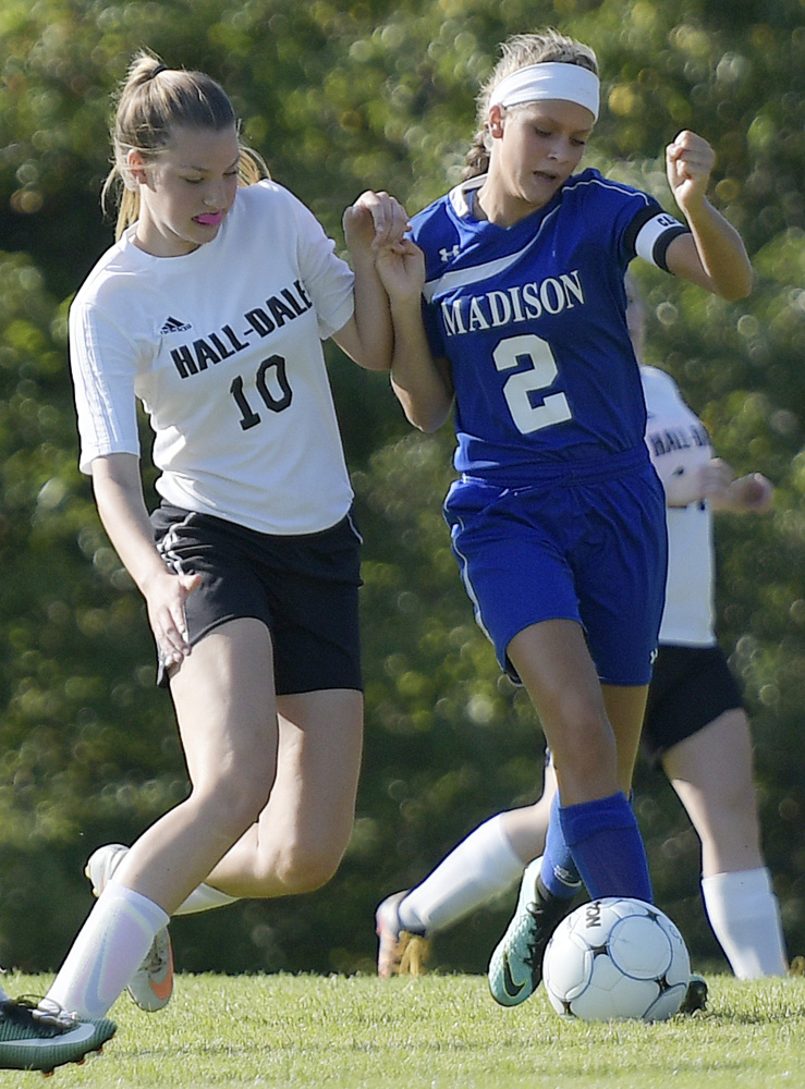 Madison senior Jillian Holden, right, and Hall-Dale freshman Olivia Bourque make contact during a Mountain Valley Conference game Tuesday afternoon in Farmingdale.