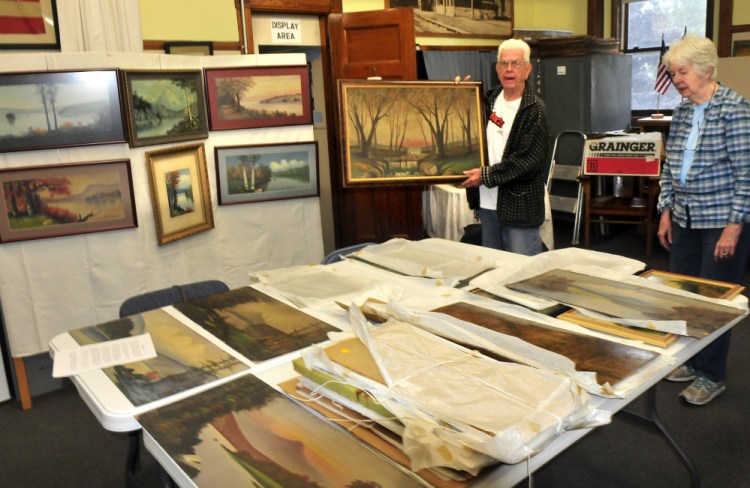 Lon Pelton, a relative of the late artist Willis Pelton, and his wife, Jane, look over artwork that will be part of a show from 10 a.m. to 3 p.m. on September 16 at the Old Point Avenue School in Madison. Willis Pelton lived in Starks in the late 1800s.