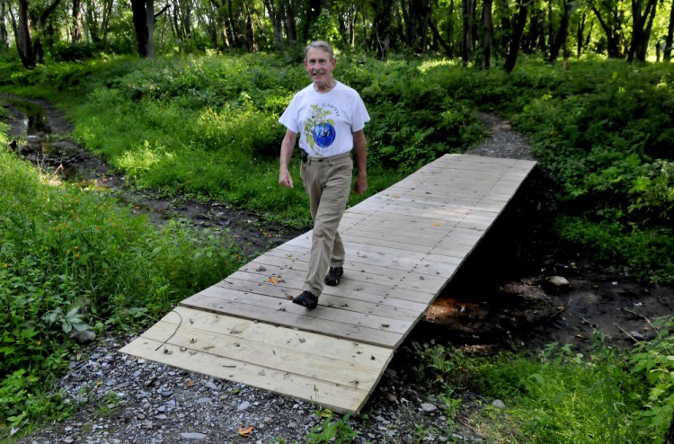 Peter Garrett walks on a new bridge along the Leeman Island trail in Waterville on Tuesday.