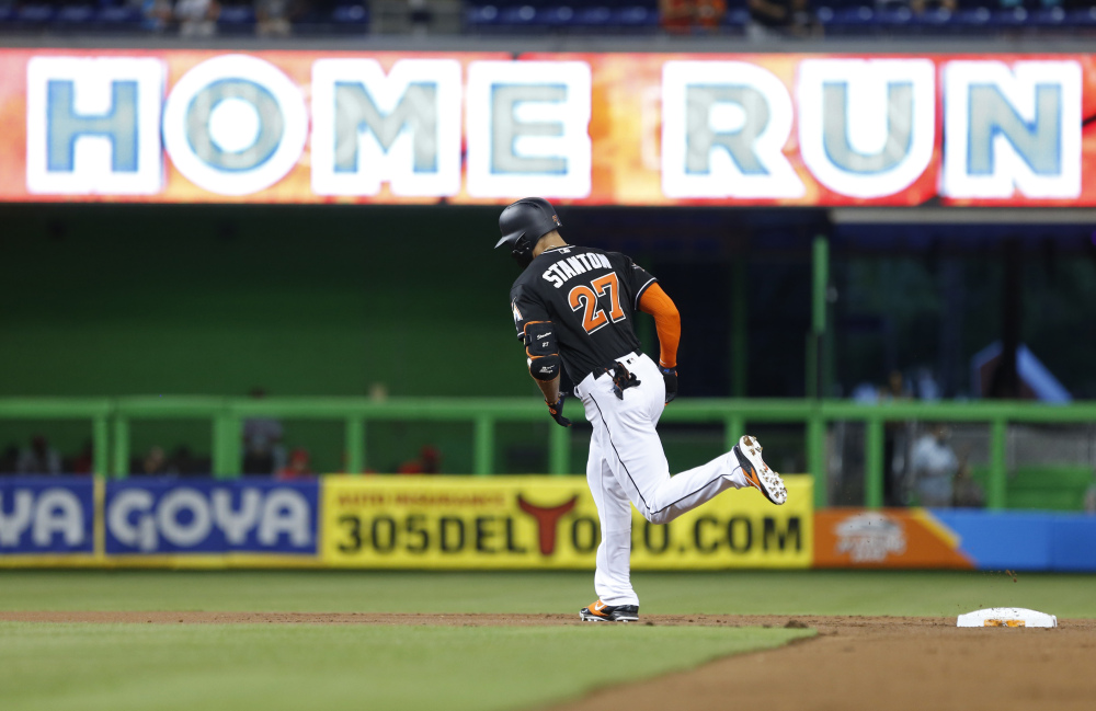 Miami Marlins slugger Giancarlo Stanton rounds second base after hitting a home run during the first inning of a Sept. 2 game against the Phillies in Miami.