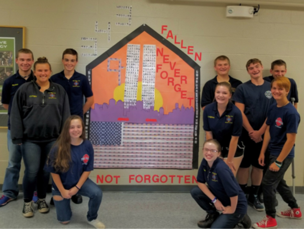 Firefighter class, left side of tribute, are Christina Smedberg, kneeling; in back, from left are Tyler Noonan, Coby Dangler and Jared Goss. On the right side of tribute are McKinley Lynn Carignan, kneeling; in the middle, from left are Ashley Leighton and AJ Maroney; and in back, from left are Zac Campbell, Joe Libby-Cornette and Kevin Trask.