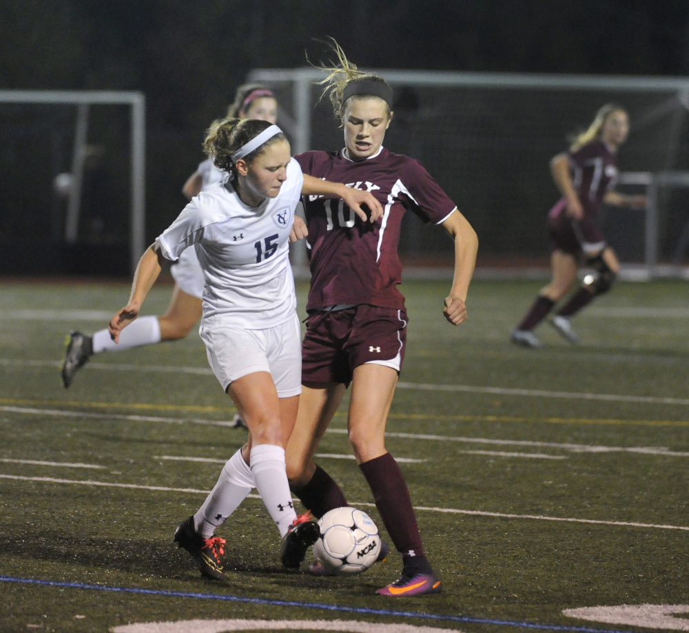 YARMOUTH, ME - OCTOBER 17: Yarmouth vs. Greely girls soccer game. Yarmouth's #15, Cory Langenbach, vies with Greely's #10, Courtney Sullivan, for control of the ball. (Photo by John Ewing/Staff Photographer)