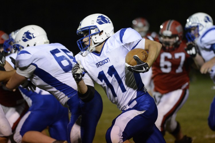 Madison running back Eric Wescott heads up the field during a Class D South game Friday night.
