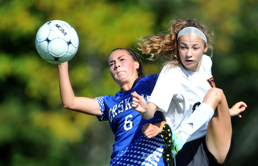 Winslow High School's Katie Doughty (8) right, battles for the ball with Erskine Academy's Lauren Wood (6) on Saturday at Kennebec Savings Bank Field in Winslow.