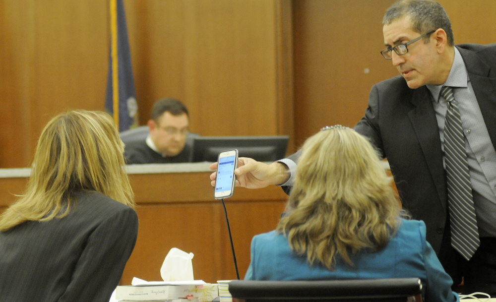 Defense attorney Charles Ferris shows assistant district attorney Tracy DeVoll a message on Danielle Jones' cellphone during Jones' civil trial Nov. 29, 2016, in Augusta.