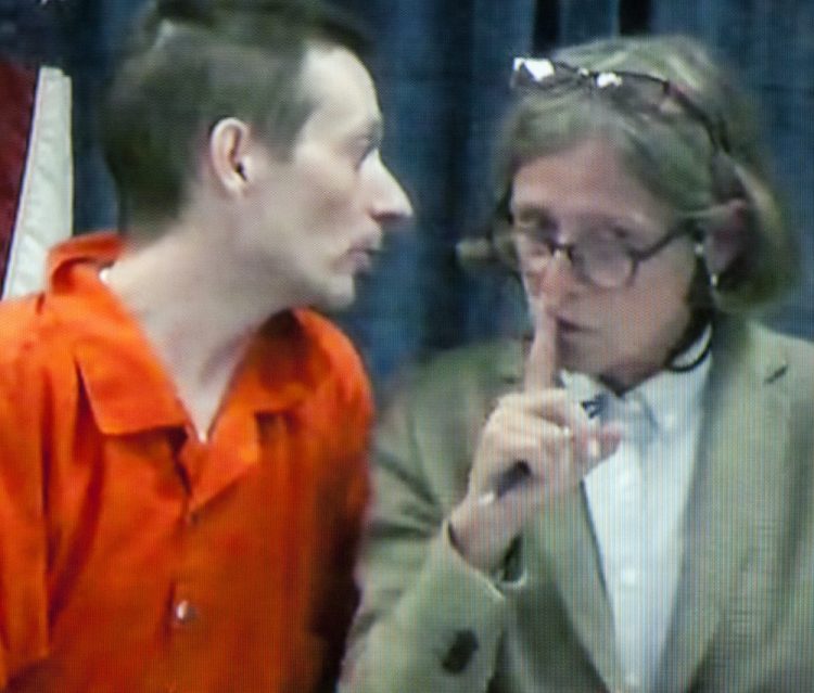 Attorney Lisa Whittier, right puts her finger to lips to signal Scott Bubar to stop speaking as they appear in court via video from Kennebec County jail on May 30 at the Capital Judicial Center in Augusta.