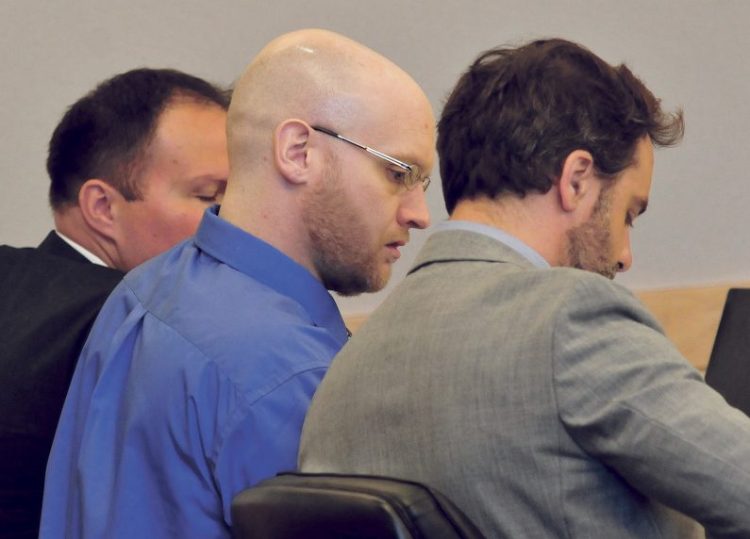 Defendant Robert Burton, center, and his defense team of attorneys Zachary Brandmeir, left, and Hunter Tzovarras listen on Monday in Penobscot Superior Court in Bangor during opening statements in his murder trial in connection with the death of Stephanie Gebo. Testimony is scheduled to continue Wednesday.
