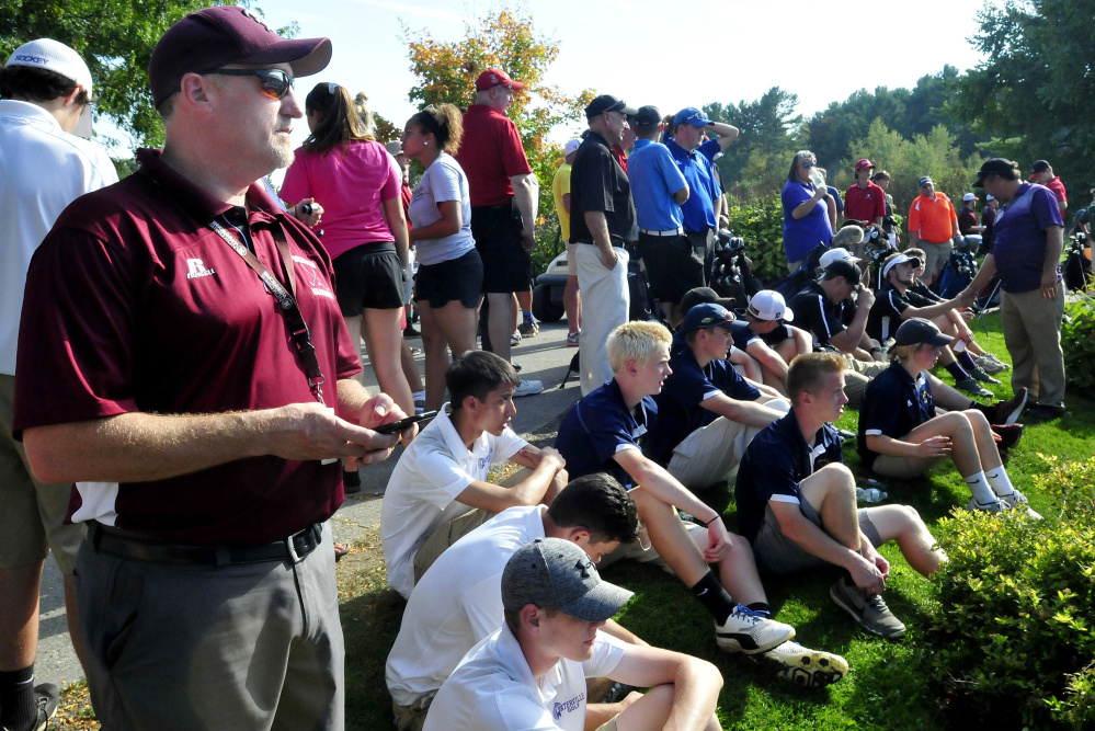 Nokomis golf coach Matt Brown waits with players from area schools for results of the Kennebec Valley Athletic Conference qualifier Tuesday at Natanis Golf Course in Vassalboro.