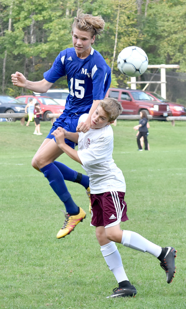 Mountain Valley's Espen Lamberg (15) out-leaps Monmouth's Cody Michaud for a header during a Mountain Valley Conference game Tuesday in Monmouth.