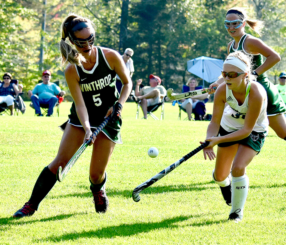 Winthrop's Olivia Simonson and Spruce Mountain's Emily Castonguay battle for the ball in a field hockey game in Jay on Wednesday,
