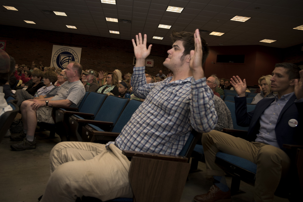 Ryan Murphy, of Portland, shows his agreement by waving his hands during a Democratic gubernatorial candidates' forum Thursday night at the University of Maine at Augusta. The Thursday evening event was hosted by the Kennebec County Democratic Party.