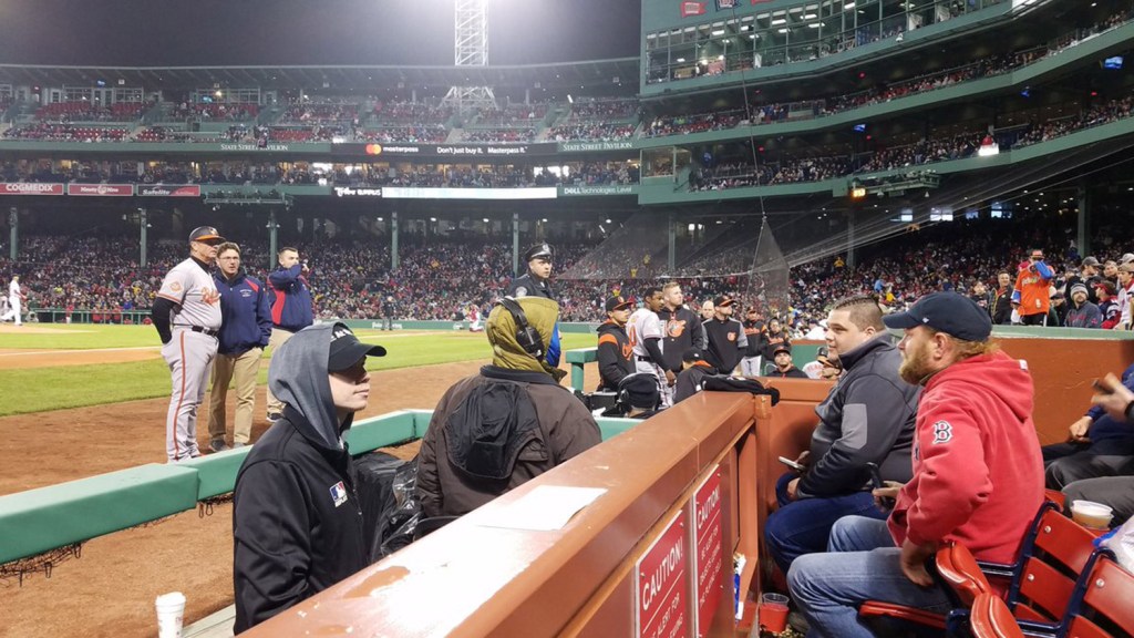 In this photo provided by Avi Miller, security watches after Baltimore Orioles center fielder Adam Jones was taunted by racial slurs at Fenway Park in Boston, Monday, May 1, 2017. Boston Red Sox President Sam Kennedy apologized to Jones Tuesday, May 2, 2017. Massachusetts Gov. Charlie Baker, in a tweet the same day, called the behavior by fans "unacceptable and shameful." 