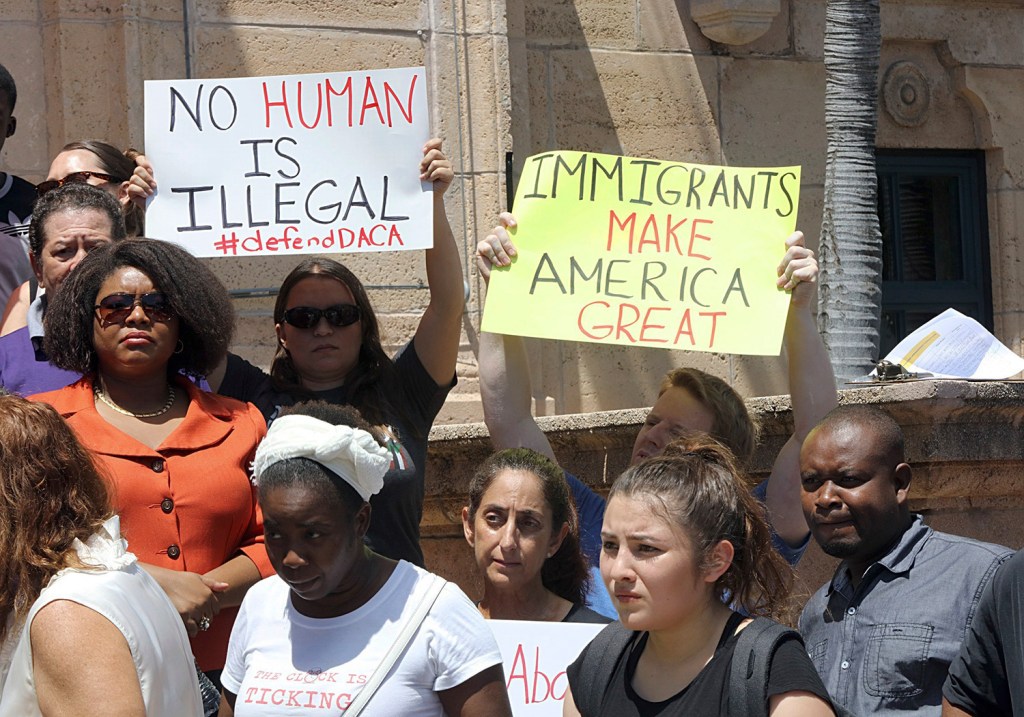 A group rallies in Miami  Tuesday to defend the Deferred Action for Childhood Arrivals program. President Trump began dismantling the DACA program, which protects hundreds of thousands of young immigrants who were brought into the country illegally as children. 