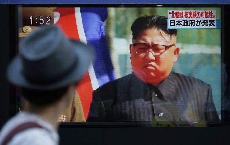 A man in Tokyo watches a news program on a public screen showing North Korean leader Kim Jong Un on Sept. 3, the day of a nuclear test by North Korea. 
