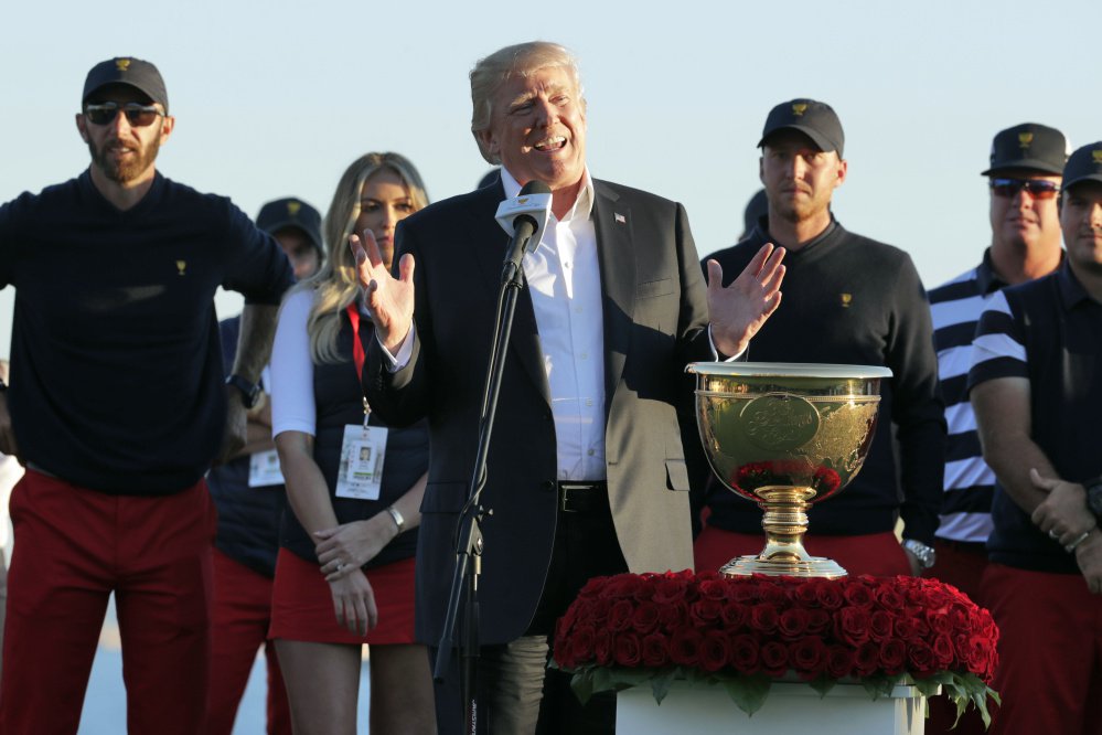 President Trump presents the winner's trophy to Team U.S.A. at The Presidents Cup in Jersey City, N.J.