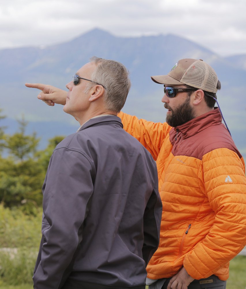 KATAHDIN WOODS AND WATERS NATIONAL MONUMENT, ME - JUNE 14: With Mount Katahdin in the background, Lucas St. Clair, right, points out features in the landscape to Interior Secretary Ryan Zinke, during a tour of the Katahdin Woods & Waters National Monument on Wednesday, June 14, 2017. Zinke was touring the monument because it is one of dozens of monuments up for review under an executive order from President Trump. St. Clair's family donated the land for the monument to the National Park Service last year. (Staff Photo by Gregory Rec/Staff Photographer)