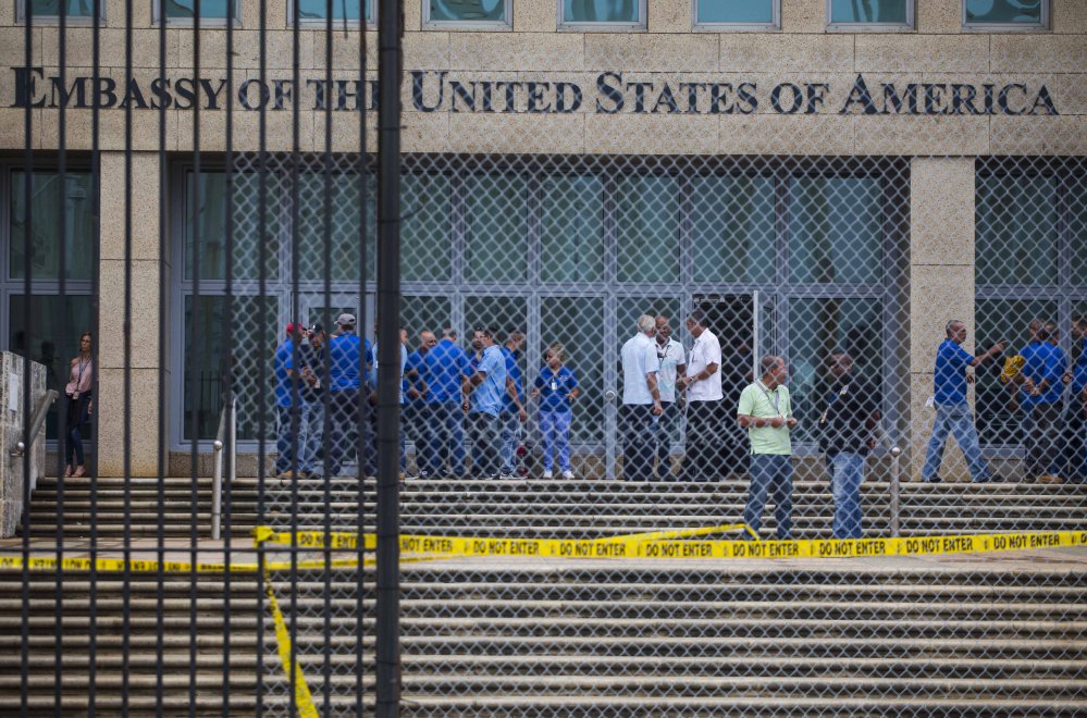 Staff members stand in the U.S. embassy facility in Havana, Cuba. At least 21 Americans in Cuba have been harmed by strange attacks over the last year.  (AP Photo/Desmond Boylan, File)