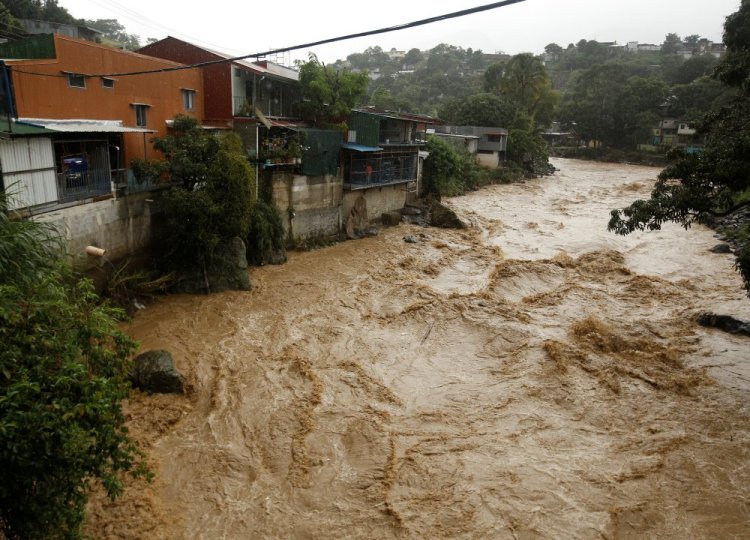 The flooded Tiribi River is seen during heavy rains from Tropical Storm Nate in San Jose, Costa Rica, on Thursday.