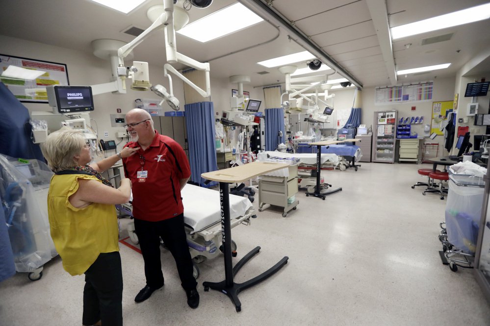 Toni Mullan, left, adjusts the shirt of Brad Skillang in the trauma unit at the University Medical Center on Tuesday in Las Vegas. Skillang and Mullan are clinical nurse supervisors in the trauma unit, and were on duty as victims of Sunday's mass shooting began to arrive.