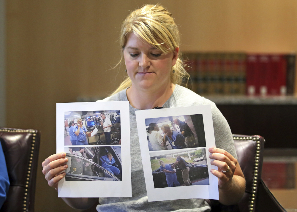 FILE - In this Sept. 1, 2017, file photo, nurse Alex Wubbels displays video frame grabs from Salt Lake City Police Department body cams of herself being taken into custody, during an interview in Salt Lake City. Authorities say a Utah police officer who was caught on video roughly handcuffing a nurse because she refused to allow a blood draw has been fired. (AP Photo/Rick Bowmer, File)