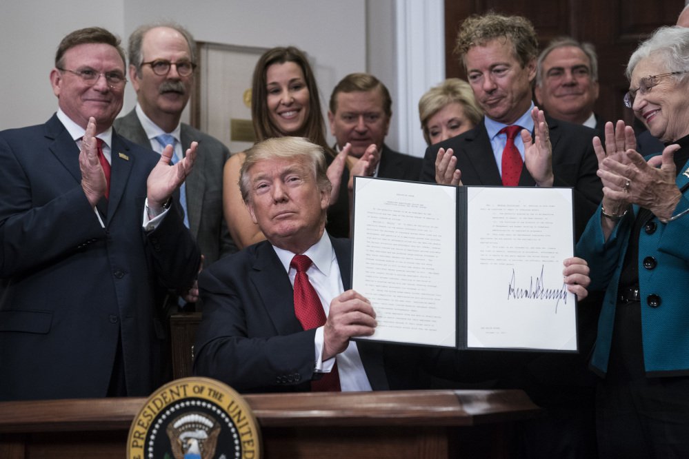 President Trump signs his executive order on health care Thursday at the White House. Later in the day, the administration confirmed that Trump will end payments to health insurers that help millions of lower-income Americans afford coverage.