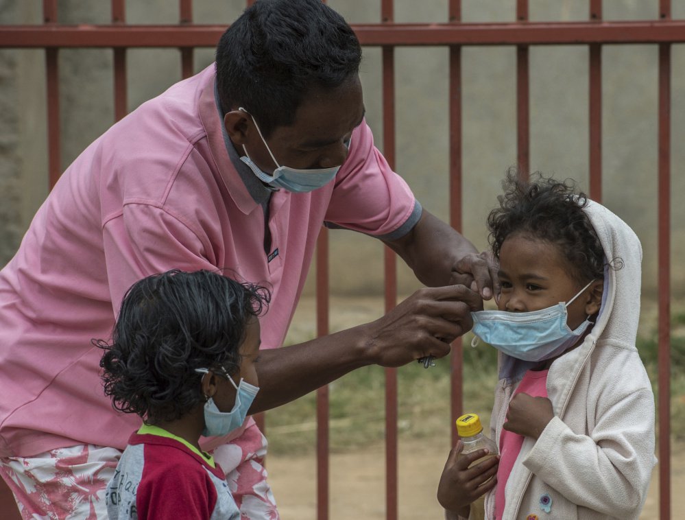 Face masks are placed on children in Antananarivo, Madagascar.  Authorities in Madagascar are struggling to contain an outbreak of plague that has killed dozens.