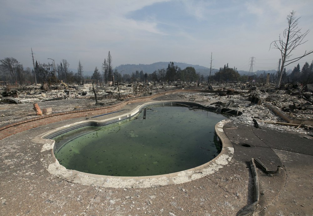 A swimming pool sits amid the charred remains of a home Monday in Santa Rosa, Calif. An estimated 2,800 homes have been destroyed by wildfires in Santa Rosa alone.