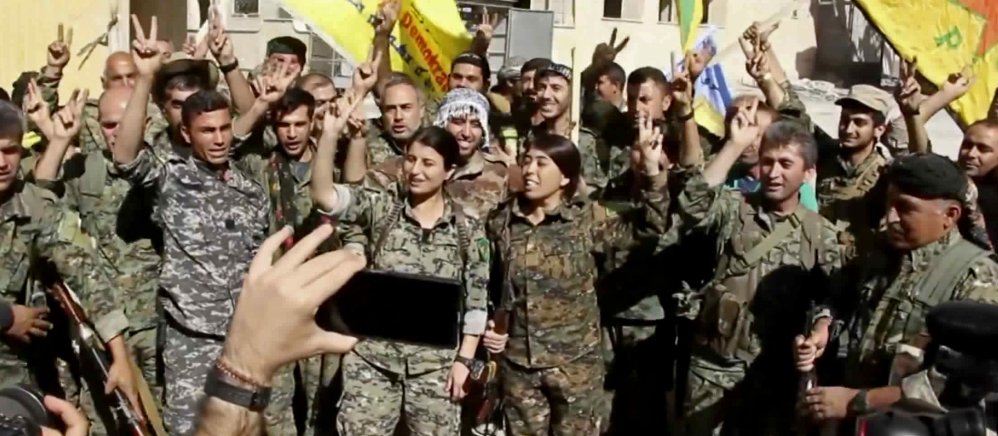 Kurdish fighters celebrate in Raqqa, Syria, once the heart of the Islamic State's caliphate.