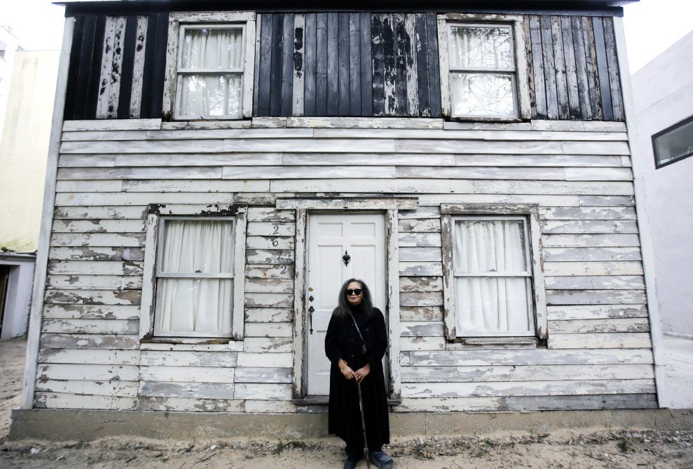 Rhea McCauley, a niece of the late civil rights activist Rosa Parks, poses in front of Parks' rebuilt house in April.