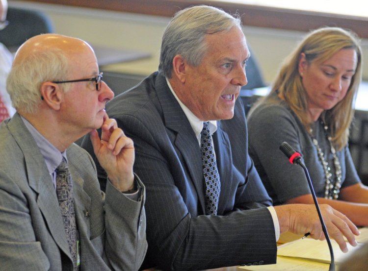 Ricker Hamilton, center, served as deputy commissioner of programs in the DHHS from 2013 until June. If confirmed as commissioner, he will head a department dogged by controversy and frequently in the public spotlight.