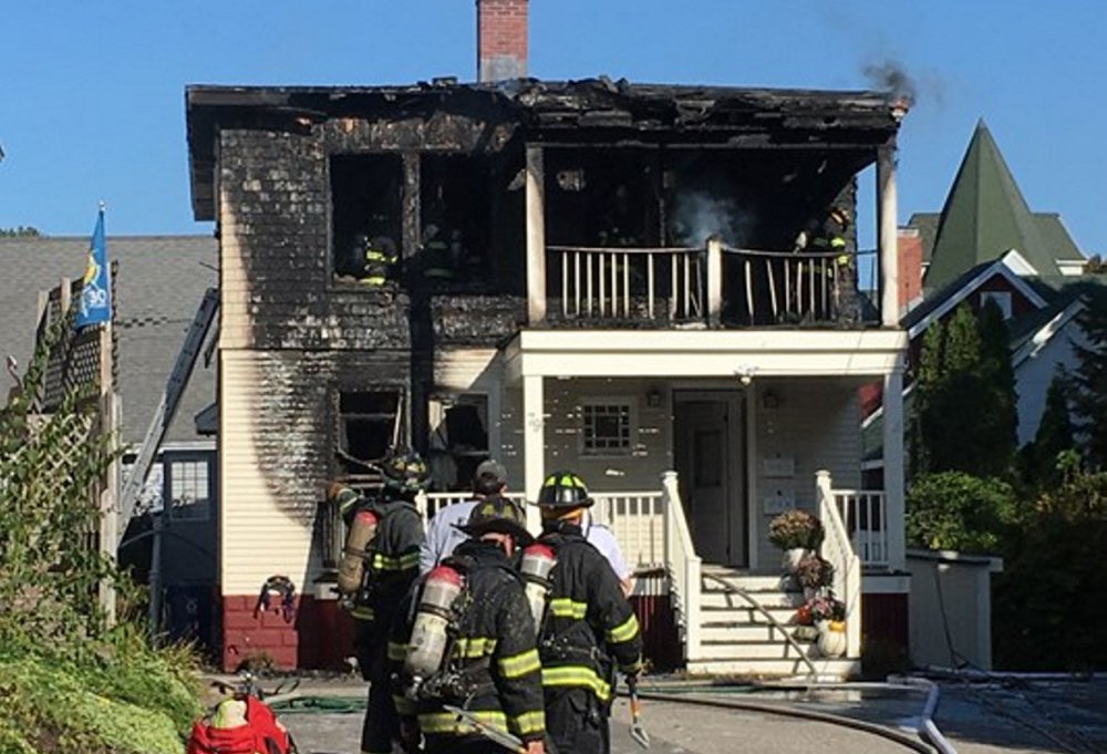 Portland firefighters gather outside 79 Lincoln St., where they battled a fire for about three hours Saturday morning. A firefighter injured his knee, a fire official said.
Photo courtesy of WCSH6