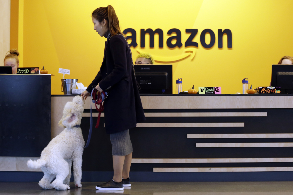 An employee brings her dog into an Amazon building in Seattle where canines are welcome. The company will decide in 2018 where to locate its second headquarters.