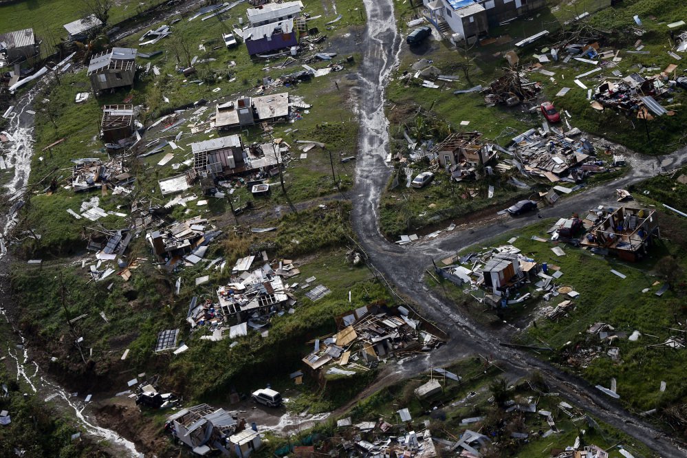 Debris scatters a destroyed community in the aftermath of Hurricane Maria in Toa Alta, Puerto Rico. The Senate gave preliminary approval Monday to a $36.5 billion hurricane relief package that would give Puerto Rico a much-needed infusion of cash. A final vote likely on Tuesday. (Associated Press/Gerald Herbert)