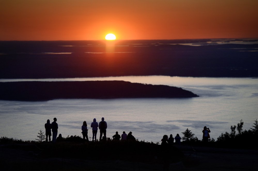 The sunrise atop Cadillac Mountain draws multitudes every year to Acadia National Park on Maine's coast. 