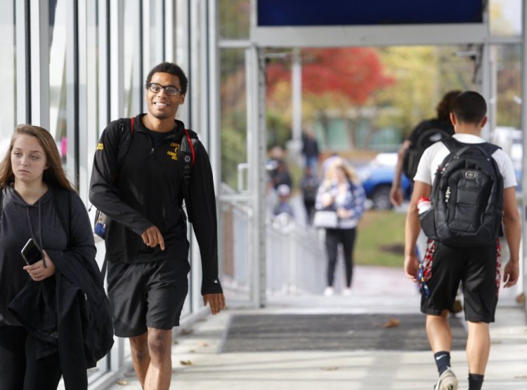 Isaac Yeboah of Portland, a communications major at the University of Southern Maine, walks across the skywalk Oct. 24 in Portland.