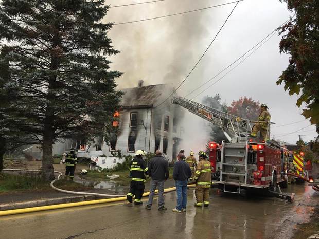 Smoke pours from the home of Sue Mills at 34 Third St. in Dixfield on Monday. Firefighters from Dixfield, Rumford, Mexico and Peru worked for hours to extinguish flames. The cause is under investigation.