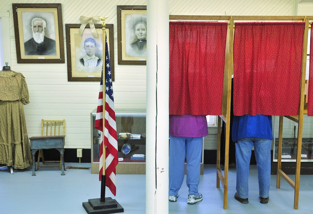 FAYETTE, ME - MARCH 15: Voters cast ballots during a special election on Tuesday April 15, 2014 to decide if the town  will withdraw from AOS 97 at Starling Hall in Fayette. The building on Route has displays from the Fayette Historical Society. (Photo by Joe Phelan/Staff Photographer)
