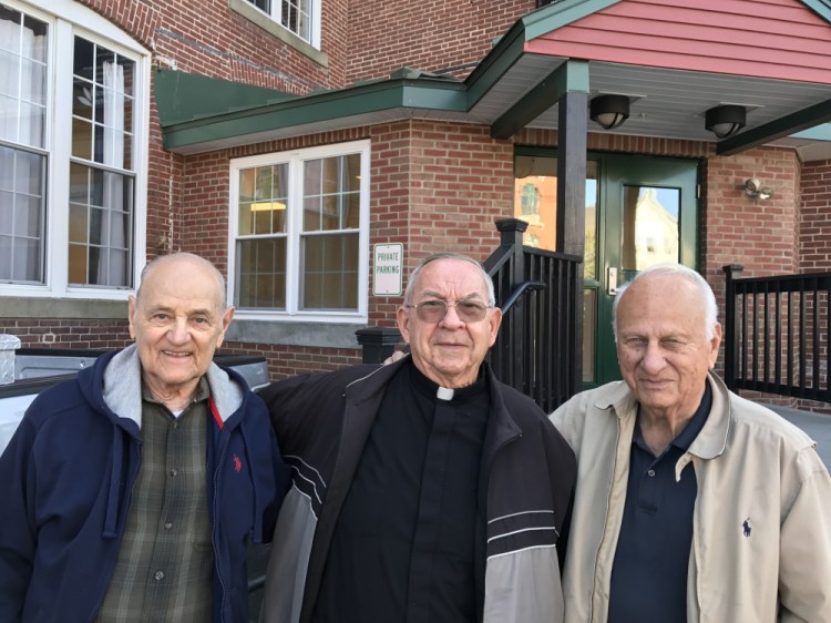 Father Real "Joe" Corriveau, center, grew up in Winthrop and now works as a pastor in Haiti. Several of his childhood friends, including Raymond Fleury, left, and Lou Carrier, right, have been raising money to rebuild a Haitian church where Corriveau worked that was destroyed in a 2010 earthquake.