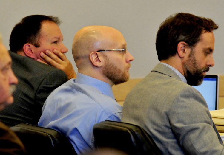 Robert Burton, center, is flanked by attorneys Zachary Brandmeir, left, and Hunter Tzorarras during his trial for the murder of Stephanie Gebo at the Penobscot Judicial Center Court in Bangor on Monday.