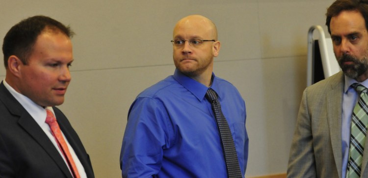 Robert Burton, center, is flanked by defense attorneys Zachary Brandmeir, left, and Hunter Tzovarras during the first day of his trial at the Penobscot Judical Center in Bangor for the murder of Stephanie Gebo on Sept. 25.