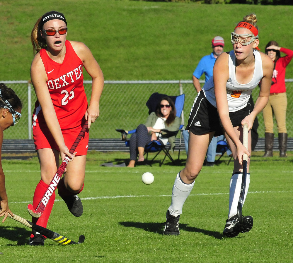 Dexter's Hayley Rossman and Winslow senior forward Haley Ryder go after a ball during a game Monday in Winslow.