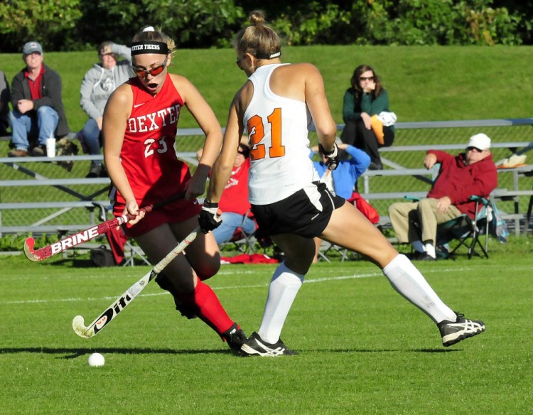 Dexter's Hayley Rossman and Winslow's Haley Ward battle for possession of ball during a game Monday in Winslow.