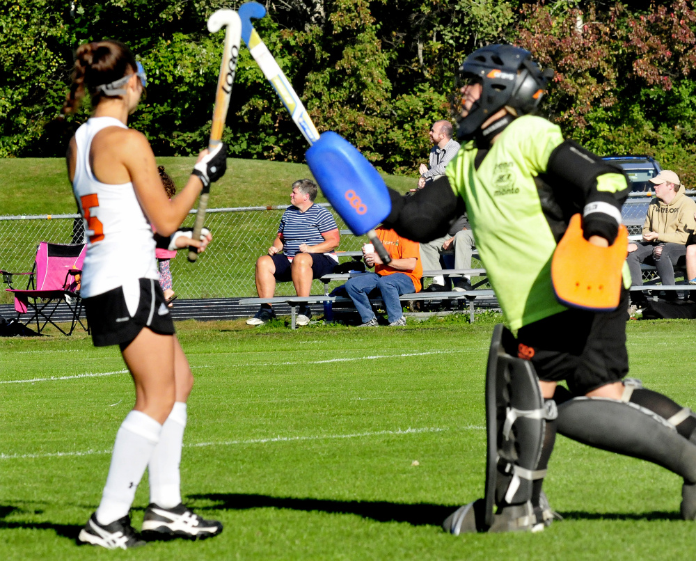 Winslow sophomore Willa Dolley, left, and senior goalie Cassie Demers celebrate after the Raiders scored against Dexter during a game Monday in Winslow.