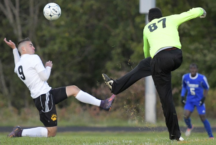 Maranacook's Micah Charette attempts to block a kick by Lewiston goalie Dido Lumu during a Kennebec Valley Athletic Conference game this season in Readfield.