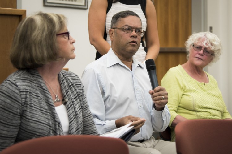 Elliot Kollman, center, of Willow Street, expresses concern Wednesday about a proposed housing development at the former mill site at the end of Maple Street. He said it should remain private property. He is joined by Ward 4 Councilor Anna Blodgett, left, and his wife, Mary Jo.