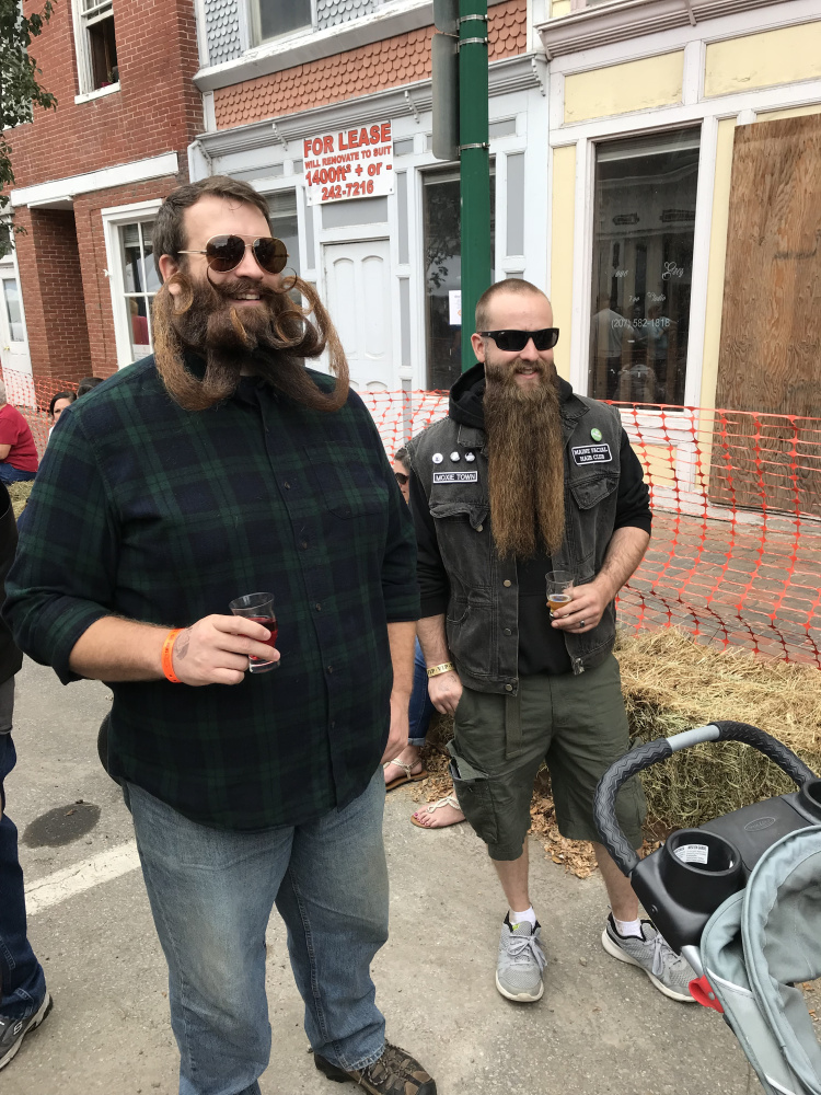 Bryce Royal, left, and Zachary LeClair talk with other members of the Maine Facial Hair Club on Saturday afternoon during the eighth annual Swine & Stein Oktoberfest in Gardiner.