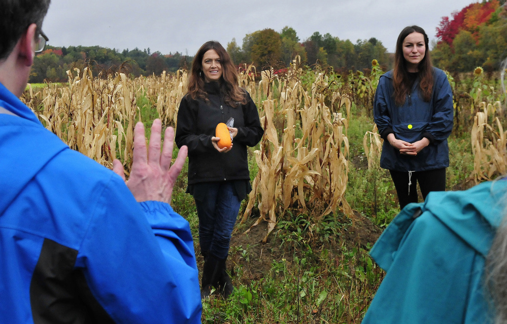Karyn Marden, left, and Ann Pollard-Ranco, both descendants of Native Americans, taught people assembled at the Sweet Land Farm in Starks on the Three Sisters technique of planting corn, squash and beans in a single mound during an Indigenous Peoples Day celebration on Monday.