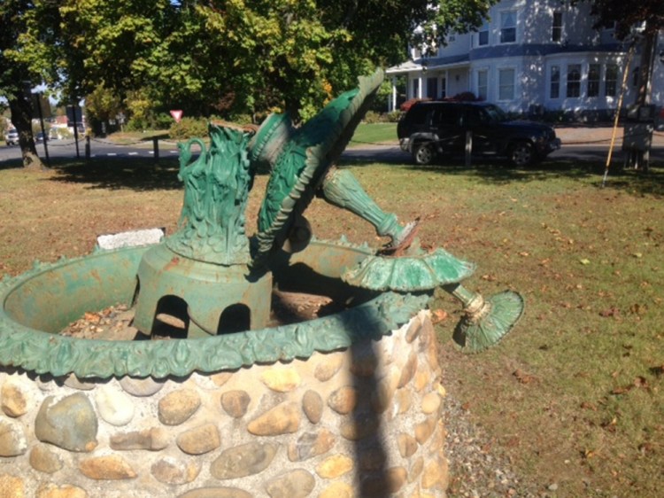 An ornate water fountain in a small grassy park on Main Street, Skowhegan, as it appeared Tuesday, having been broken by vandals a few days earlier.