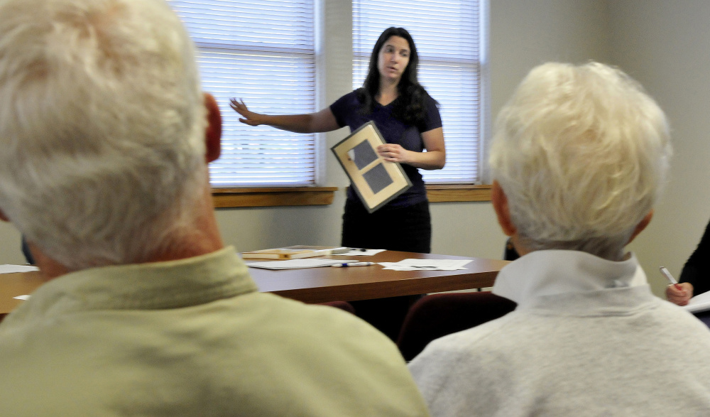 Laura Seaton, a representative of the WindowDressers program, explains on Wednesday how a window insert can reduce energy loss to members of the Vassalboro FAVOR committee.